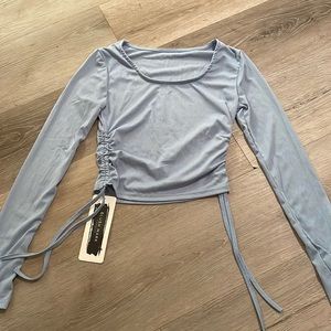 This shirt has never been worn it’s too small for me it’s a cute blue shirt!